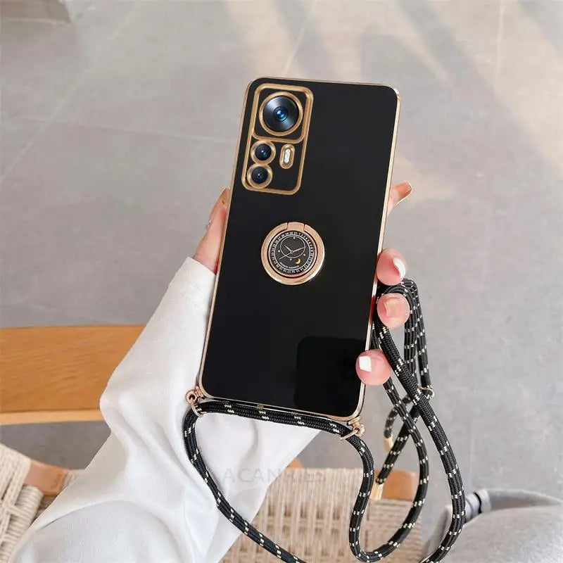 a woman holding a black phone case with a chain around it