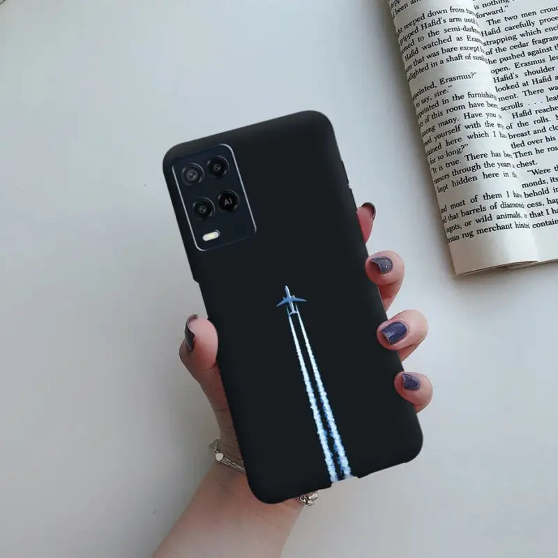 a woman holding a black phone case with a blue pen on it