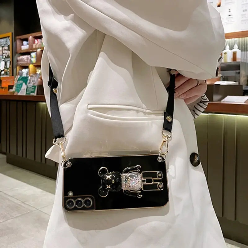 a woman holding a black purse bag