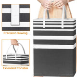 a woman holding a black and white striped tote bag