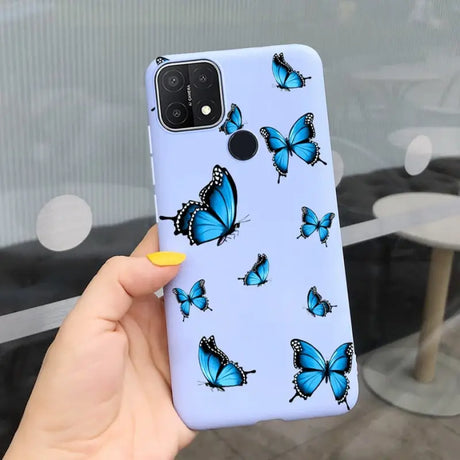 a woman holding a phone case with blue butterflies on it