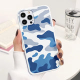 a woman holding a blue camouflage iphone case