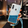 a woman holding a blue glitter phone case