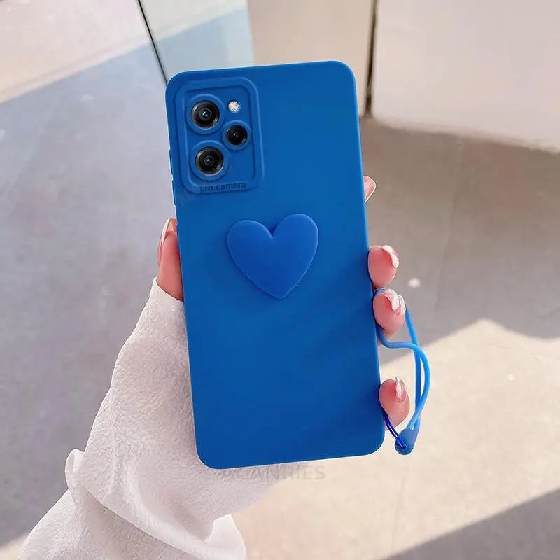 a woman holding a blue heart phone case