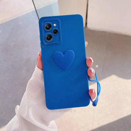 a woman holding a blue heart phone case