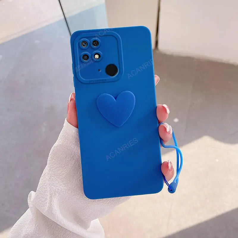 a woman holding a blue heart phone case