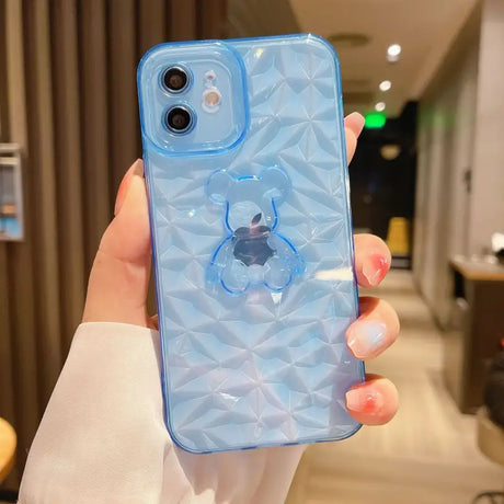 a woman holding a blue iphone case