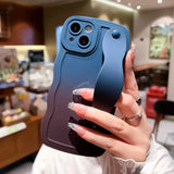 a woman holding up a blue iphone case