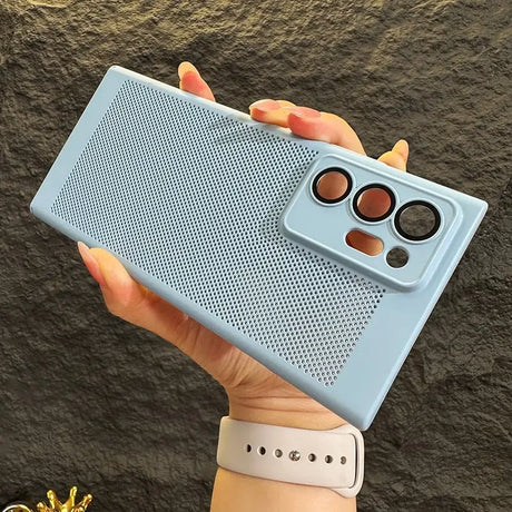 a woman holding up a blue case with a camera lens