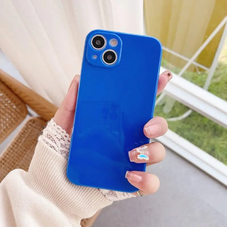 a woman holding a blue phone case