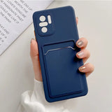 a woman holding a phone case with a card holder