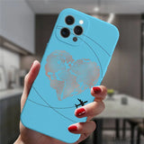a woman holding a blue phone case with a world map on it