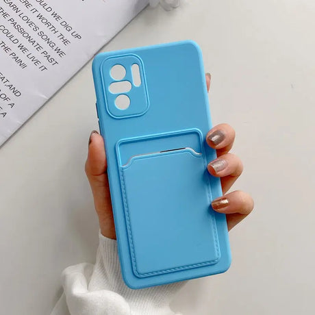 a woman holding a blue phone case