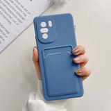 a woman holding a blue phone case