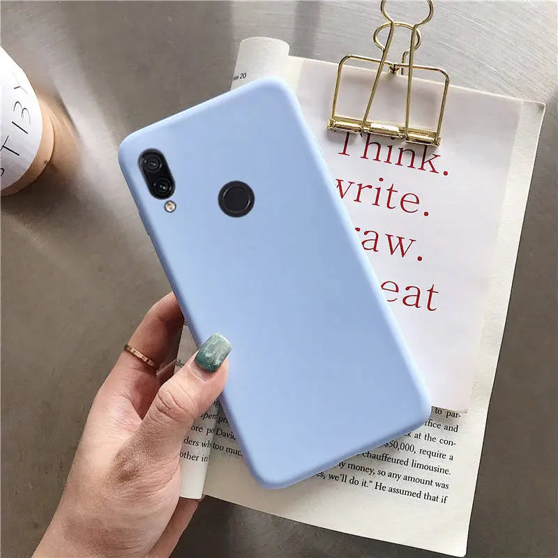 a woman holding a blue phone case