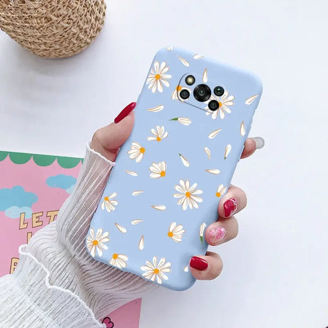 a close up of a person holding a phone with a flower pattern on it