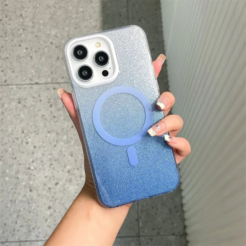 a woman holding a blue and silver glitter phone case