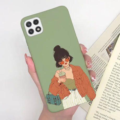 a woman holding a book and a phone case