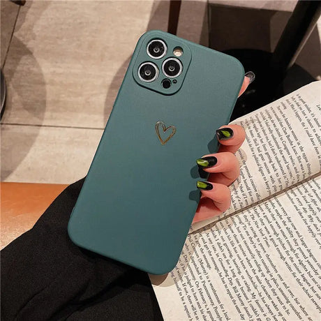 a woman holding a book and a phone case