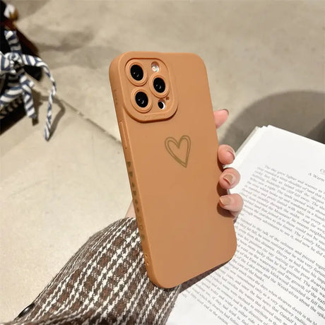 a woman holding a book and a phone case