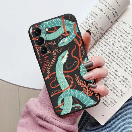 a woman holding a book and a phone case