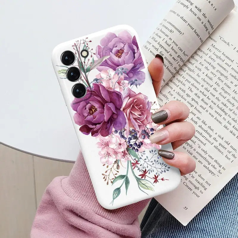 a woman holding a book and a phone case