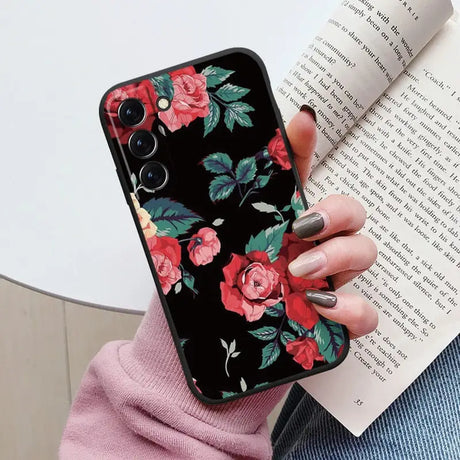 a woman holding a book and a phone case