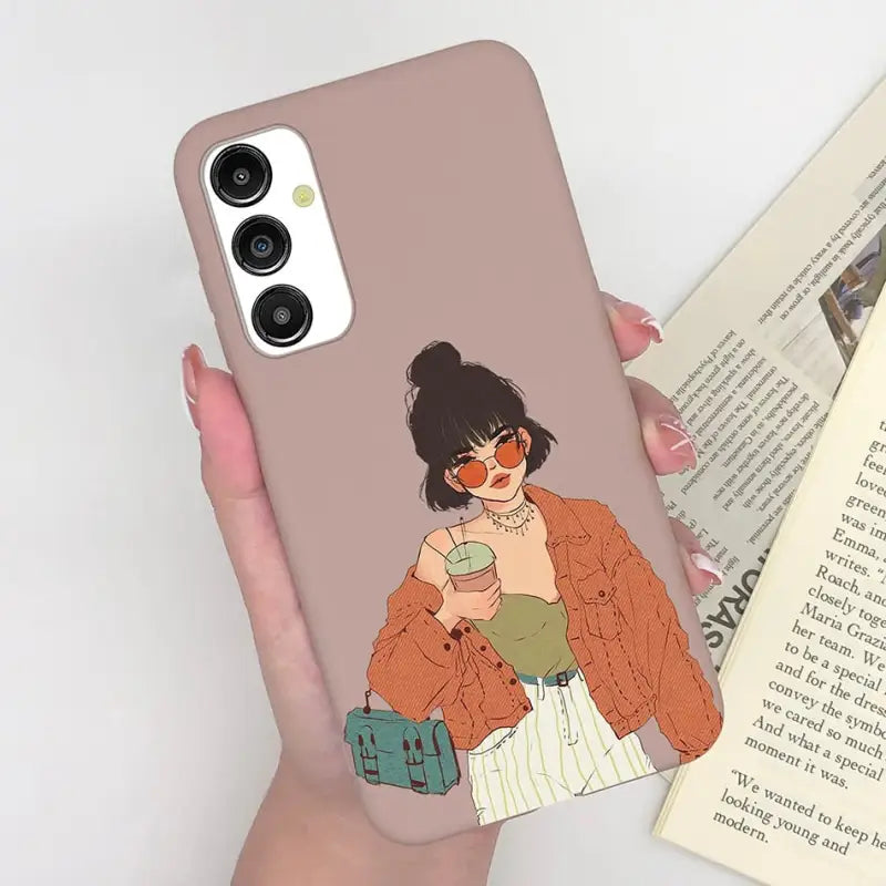 a woman holding a book and a phone case