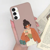 a woman holding a book and a phone case