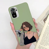 a woman holding a book and a phone case