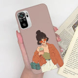 a woman holding a book and a phone case