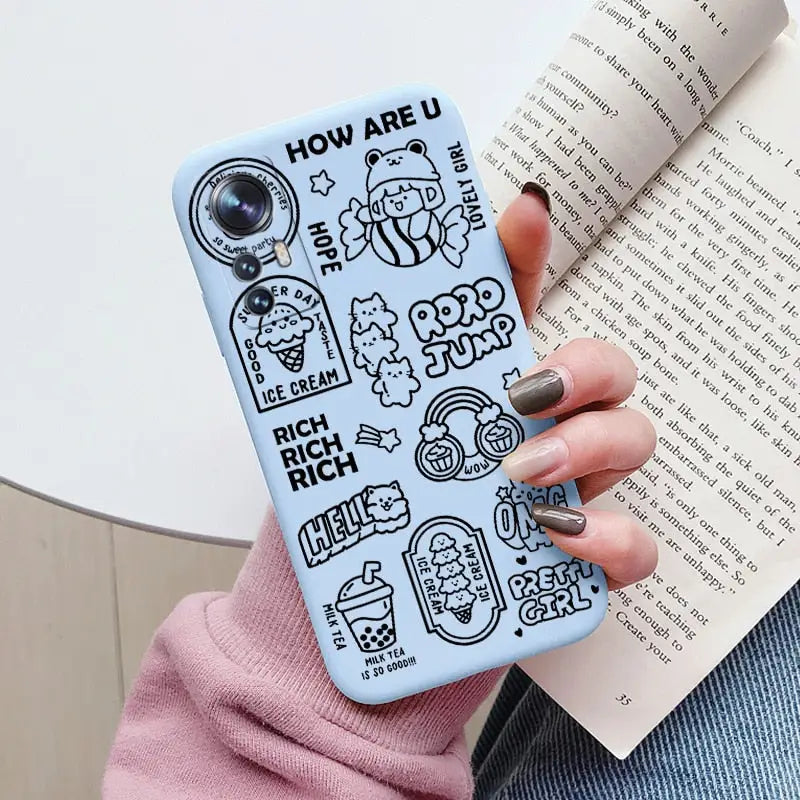 a woman holding a book and a phone case