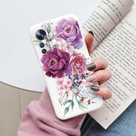 a woman holding a book and a phone case