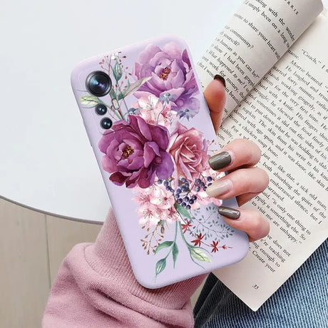 a woman holding a book and a phone case