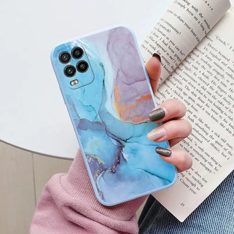 a woman holding a book and holding a phone case