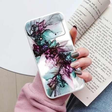 a woman holding a book and a phone case