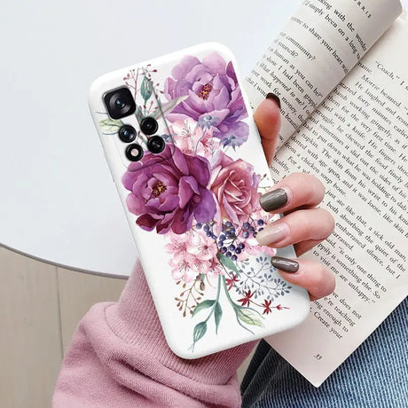 a woman holding a book and a phone case