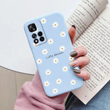 someone holding a phone case with daisies on it