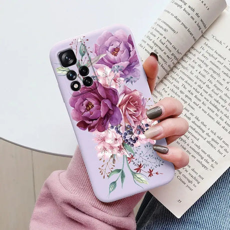 a woman holding a book and a phone case