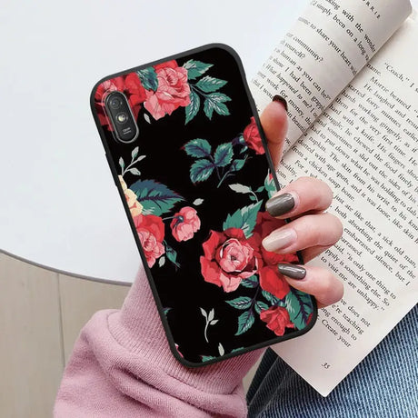 a woman holding a book and a phone case