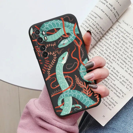 a woman holding a book and a phone case