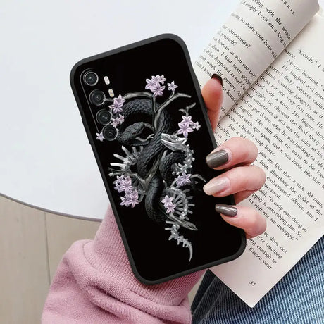 a woman holding a book and a phone case