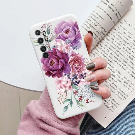 a woman holding a book and a phone case