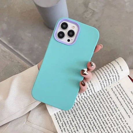 a woman holding a book and a phone case