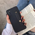 a woman holding a book and a phone case