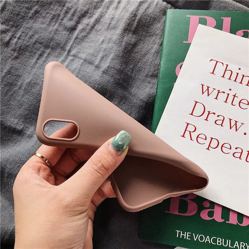 a woman holding a book with a pink cover