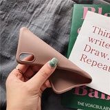 a woman holding a book with a pink cover