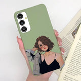 a woman holding a book and a phone case