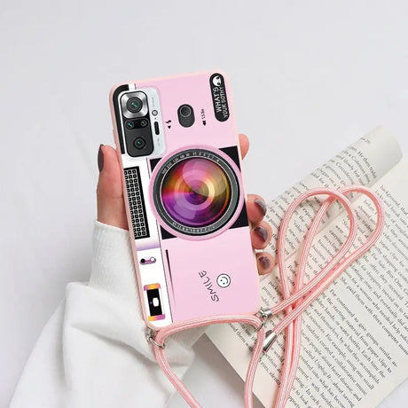 a woman holding a pink camera case