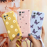 a woman holding two cases with butterflies on them